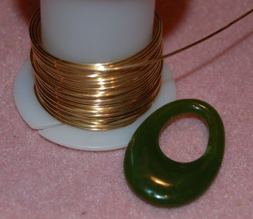 Jade pendant and spool of 20 gauge wire